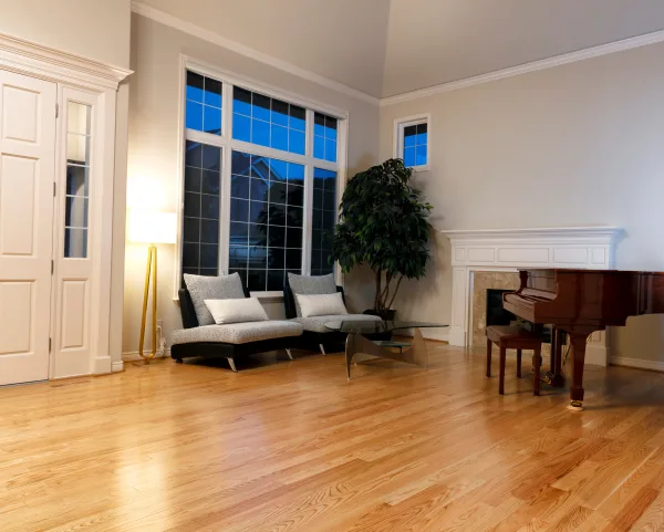 A living room with a couch and piano