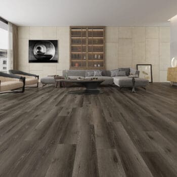 A living room with wooden floors and grey furniture.